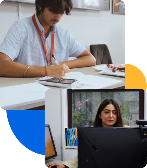 Person writing with calculator; another working on computer screen task.