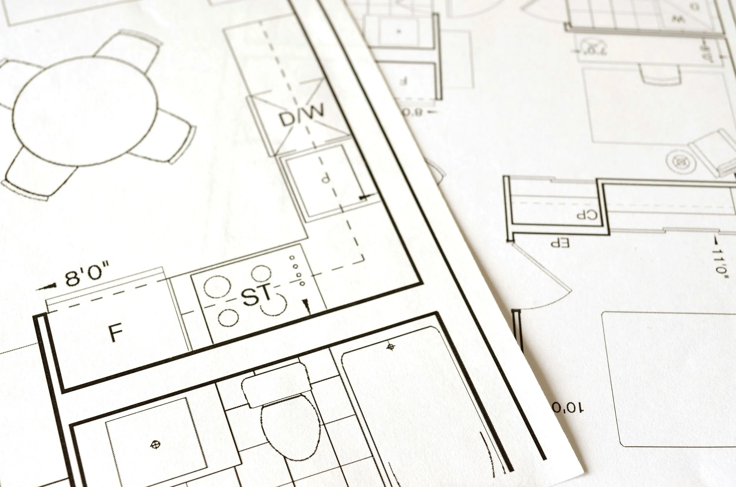 Pen resting on architectural drawings