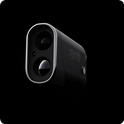 A close up of a camera on a black background.