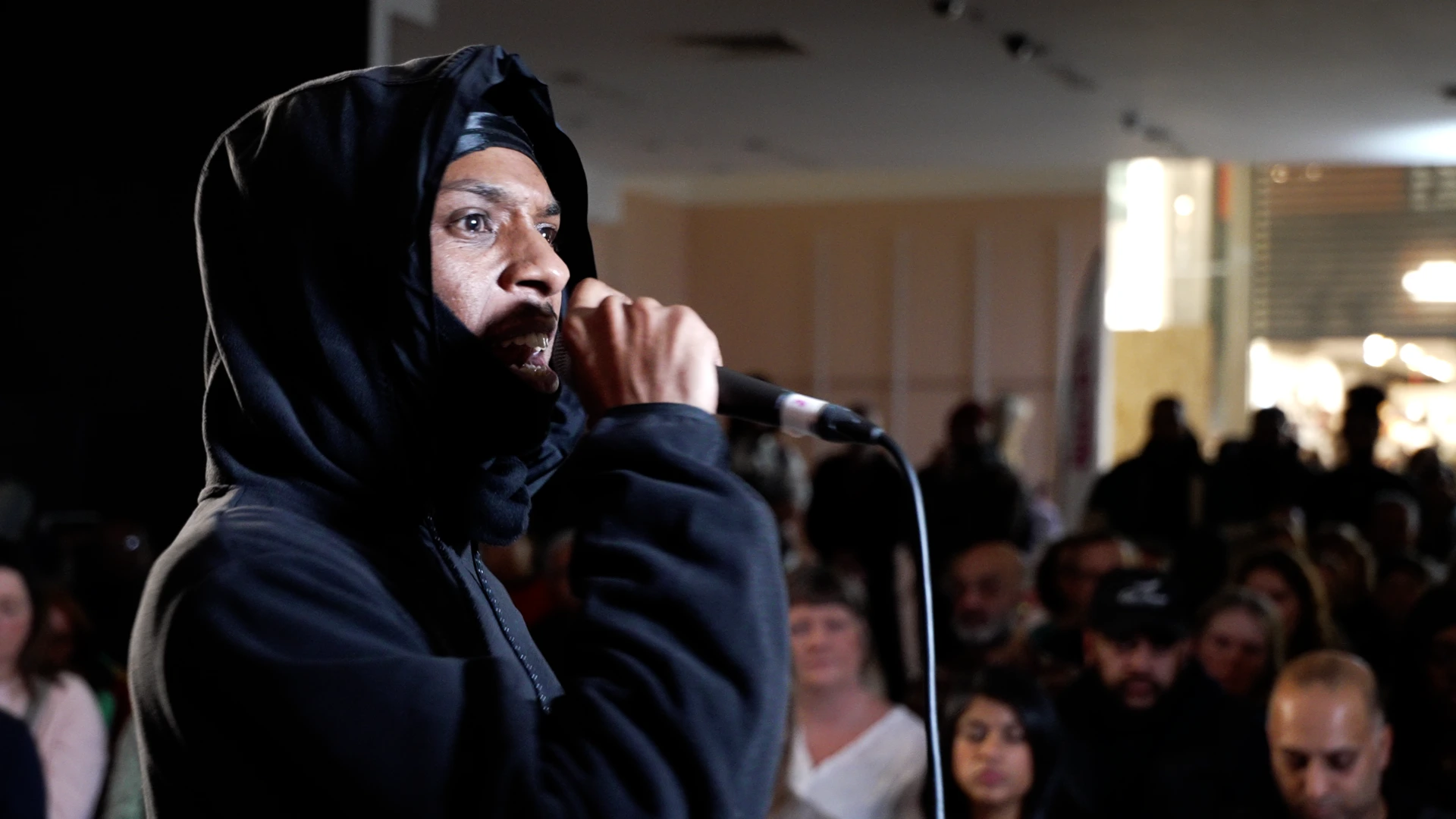 Audience watching live Grime Opera performance with orchestra and MC at community arts event | Creative Documentary by Rendah Films