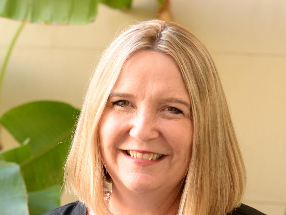 Warm smile of a New Zealand missionary serving abroad in lush landscape backgrounds. OM New Zealand