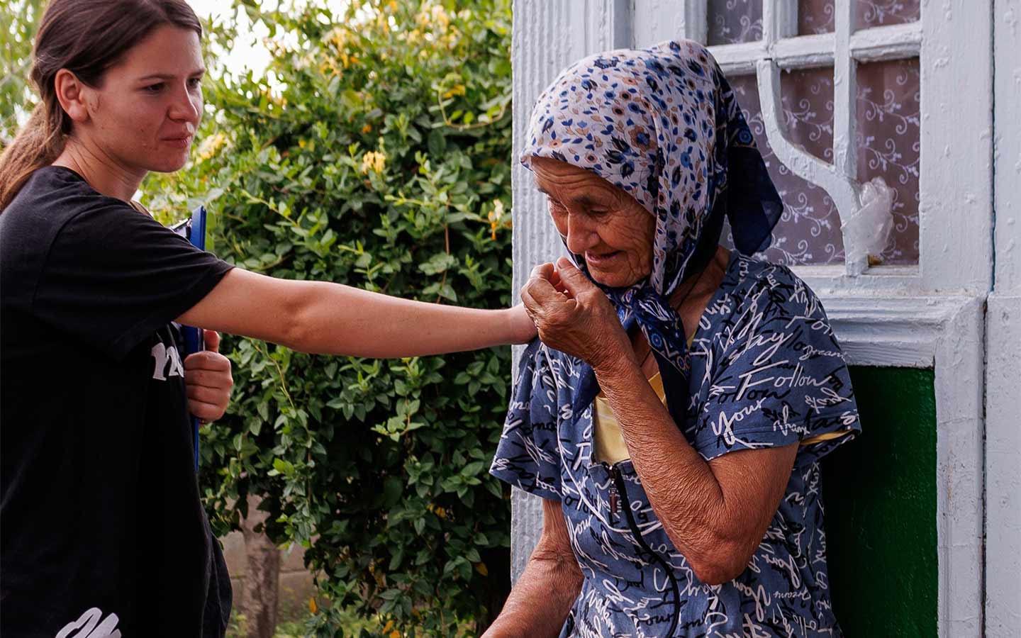 A New Zealand Christian shares the Gospel with a local elderly woman outdoors. OM New Zealand