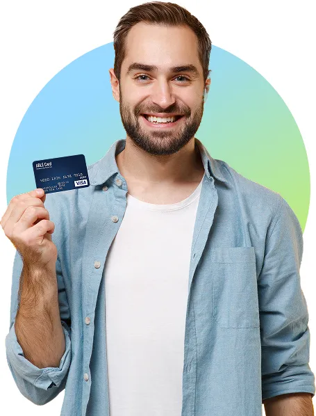 Man smiling and holding up an ABLE United Prepaid Card