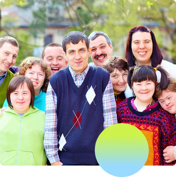 Diverse group of people with disabilities standing together and posing happily in front of the camera