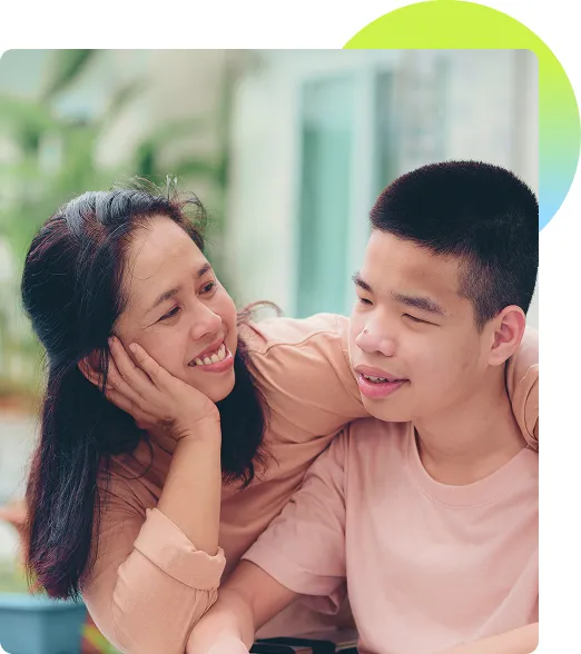 Mother smiling at her son in a wheelchair