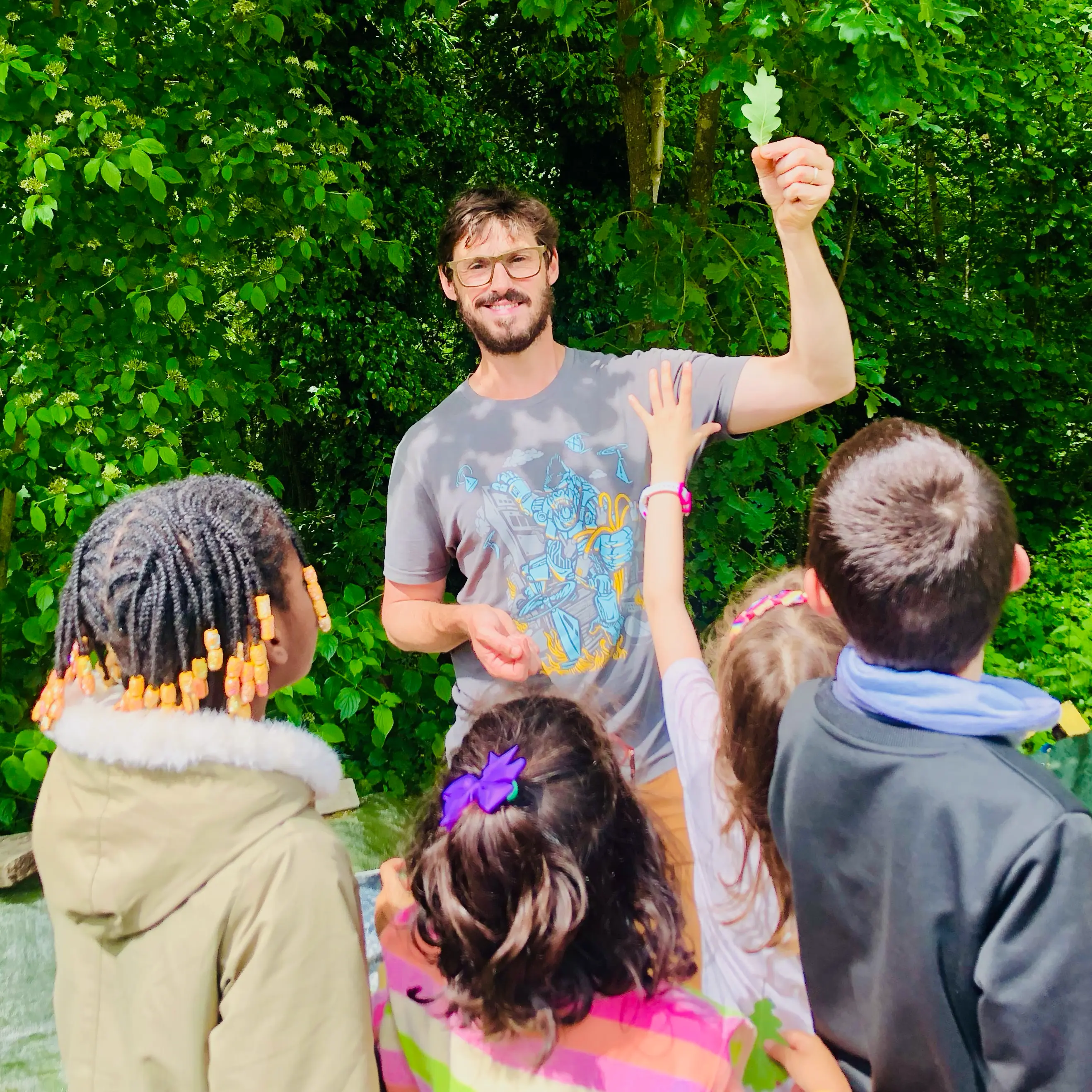 Vincent montre une feuille de chêne à des enfants