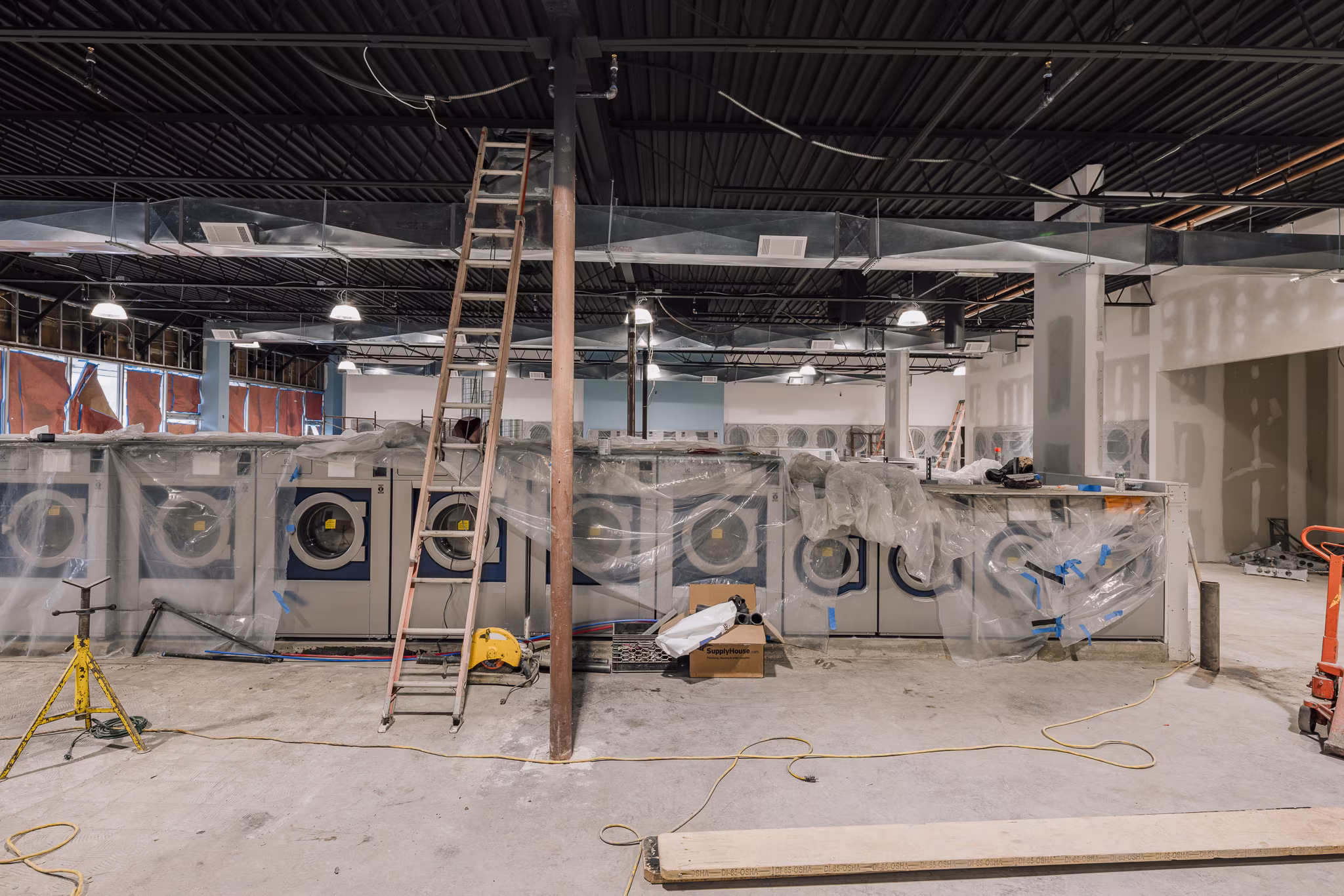 Contemporary laundromat megastore under construction with high-efficiency professional Electrolux equipment