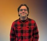Mr. Dotzler smiling in a red flannel shirt
