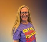 Mrs. McDonald smiling in a purple teacher shirt