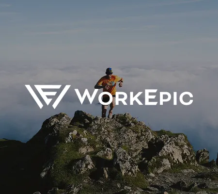 A man on the top of a rocky mountain with a white WorkEpic logo overlaid on the center of the frame.