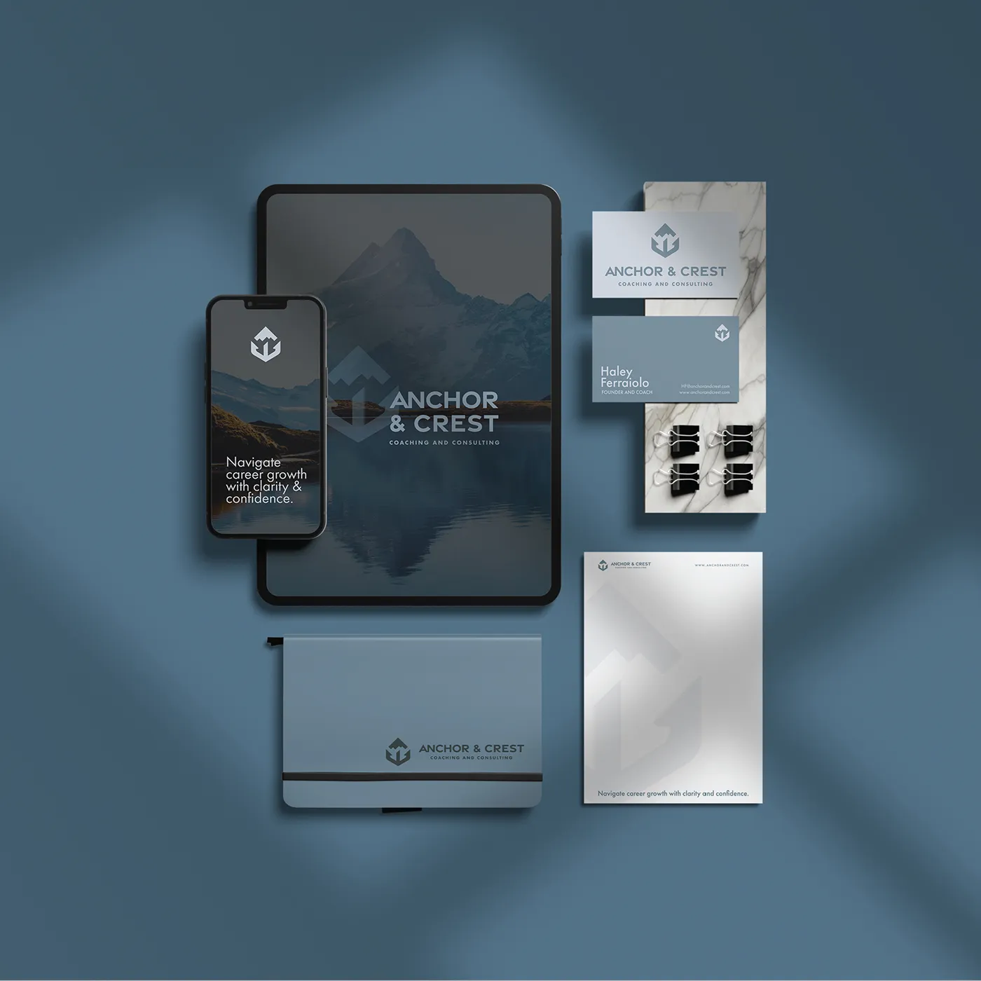 a group of business cards and a phone for Anchor & Crest Coaching and Consulting