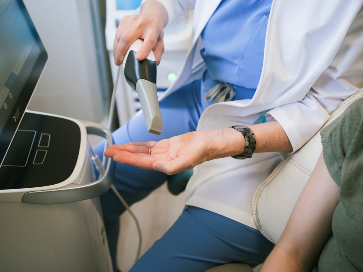 Dentist examining patient's teeth during clinical examination with dental tools
