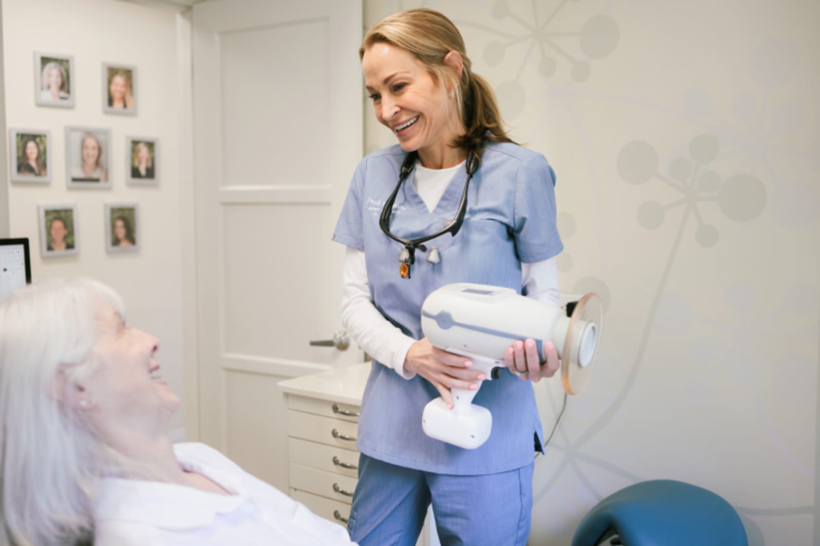 Dentist in clinical setting discussing treatment plan with patient at chair
