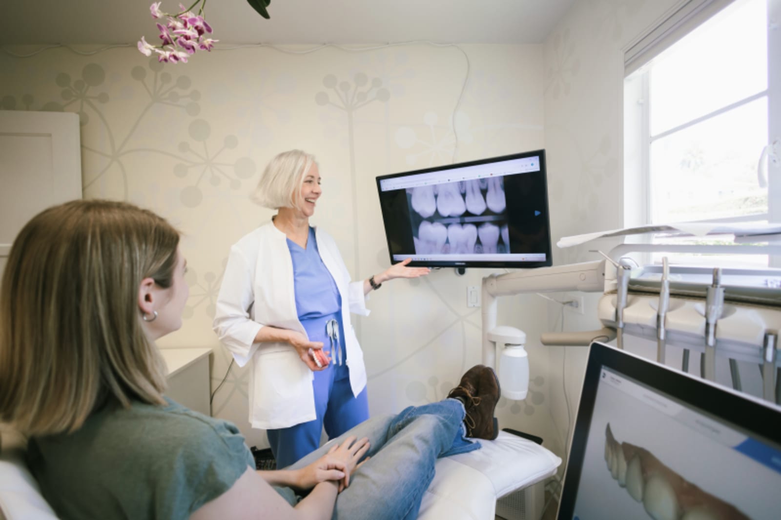 Dentist showing digital imaging on a monitor during patient consultation