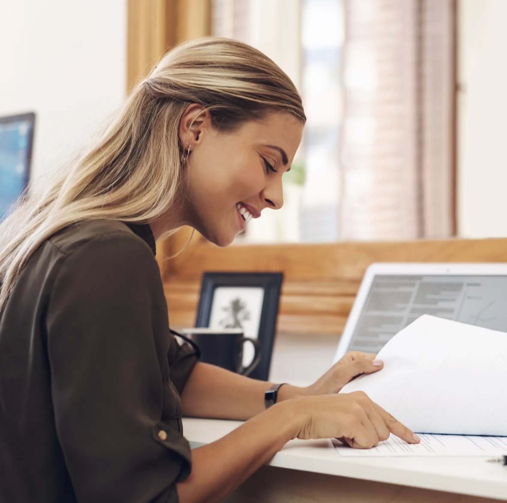 A woman sitting at a desk with a laptop