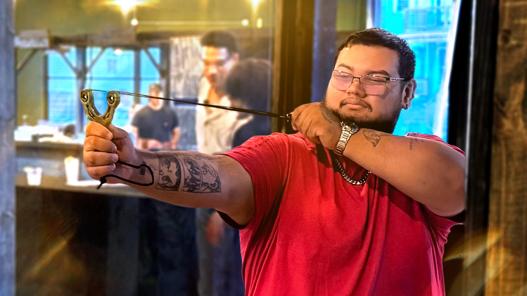 Slingshot Bar guest takes aim from their Bay.