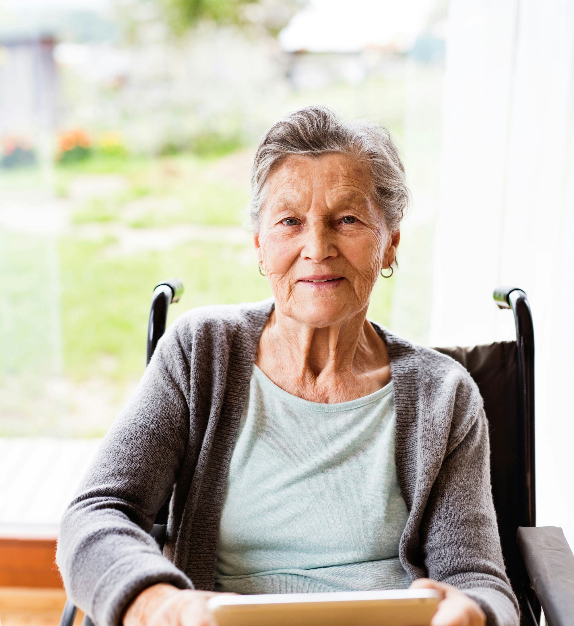 Older lady sitting in wheelchair ready to listen