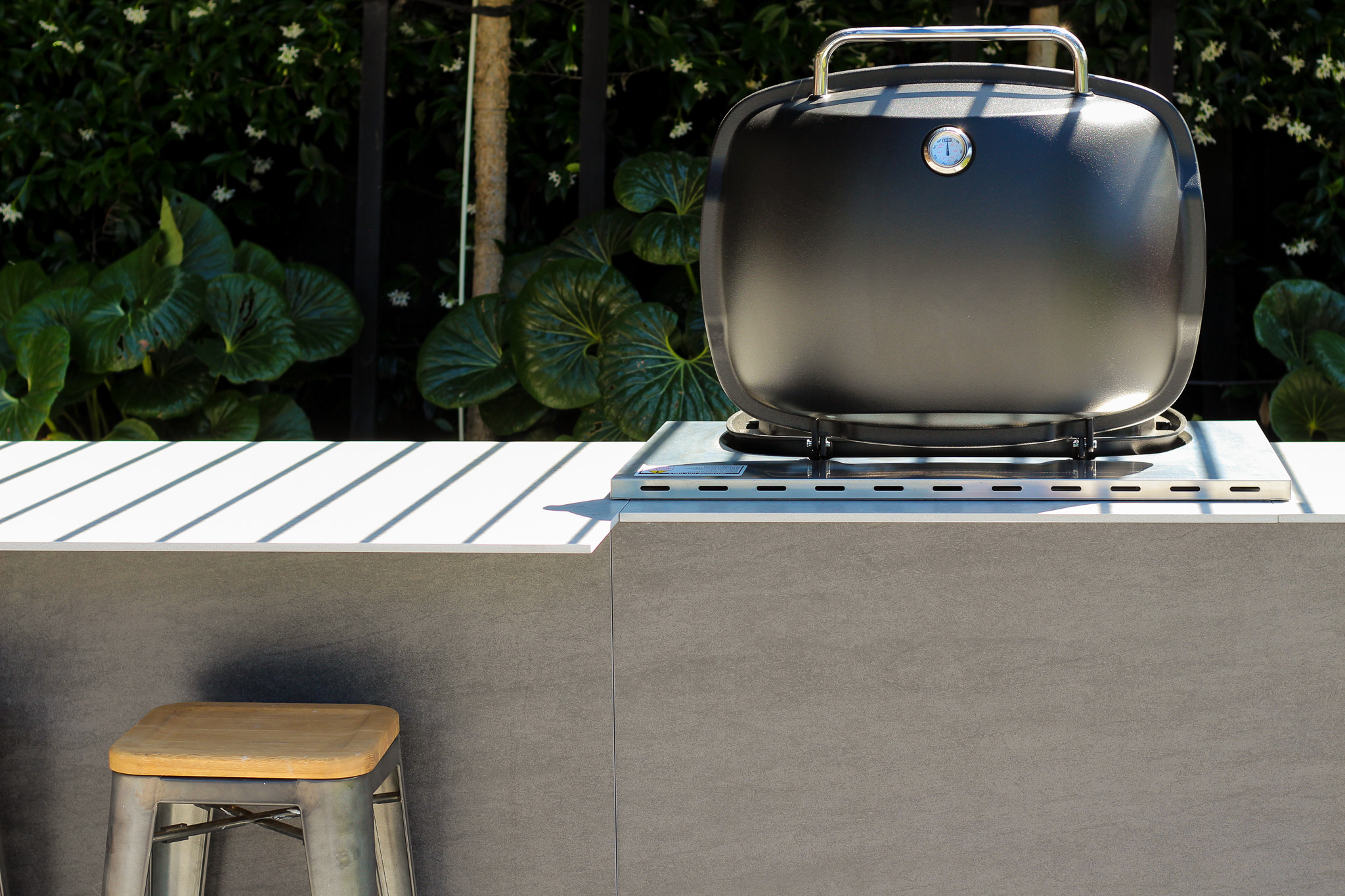 Inbuilt weber BBQ, in a wild outdoor kitchen 

