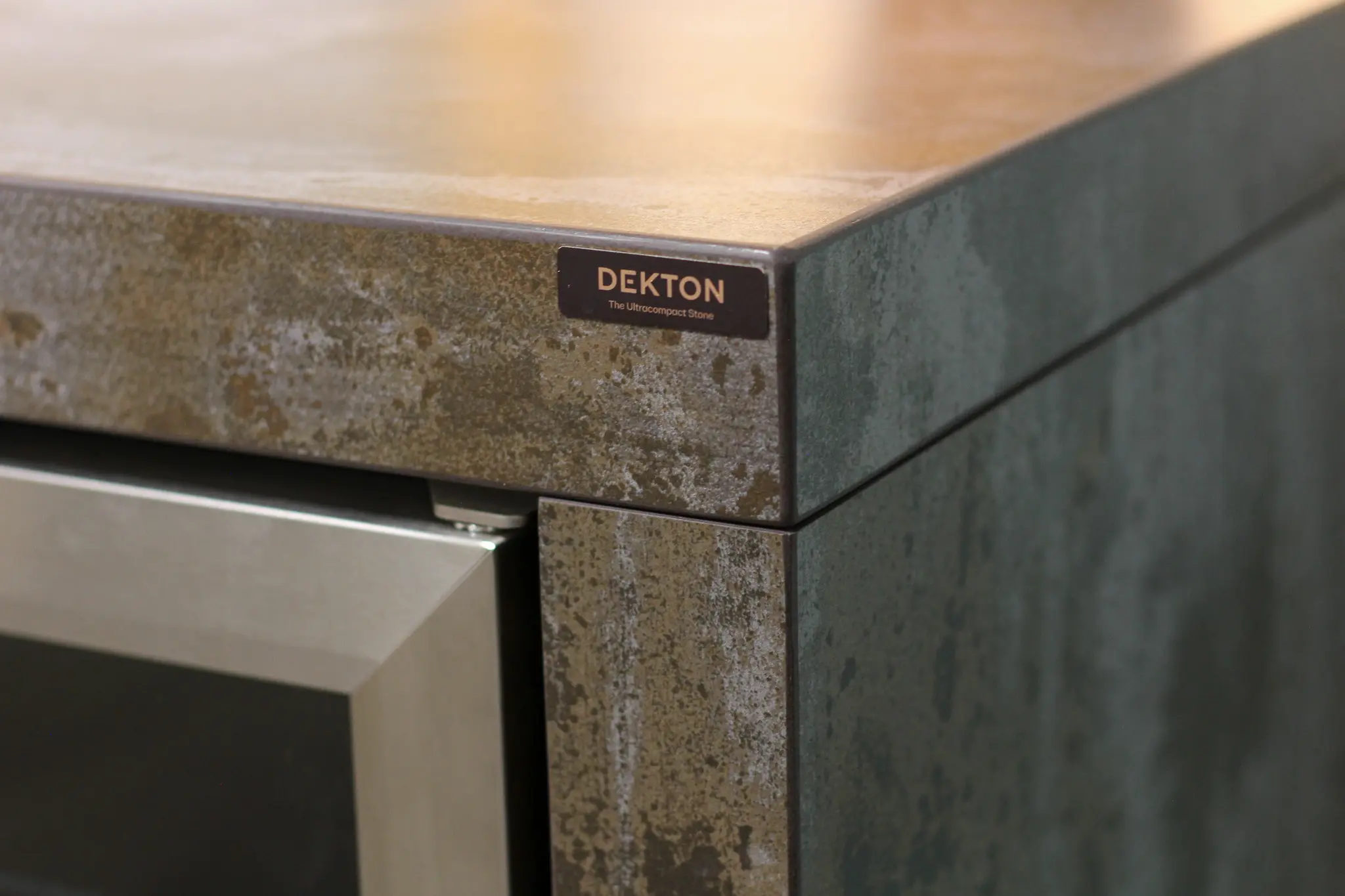 Close-up of a Dekton ultracompact stone kitchen countertop and cabinetry corner.