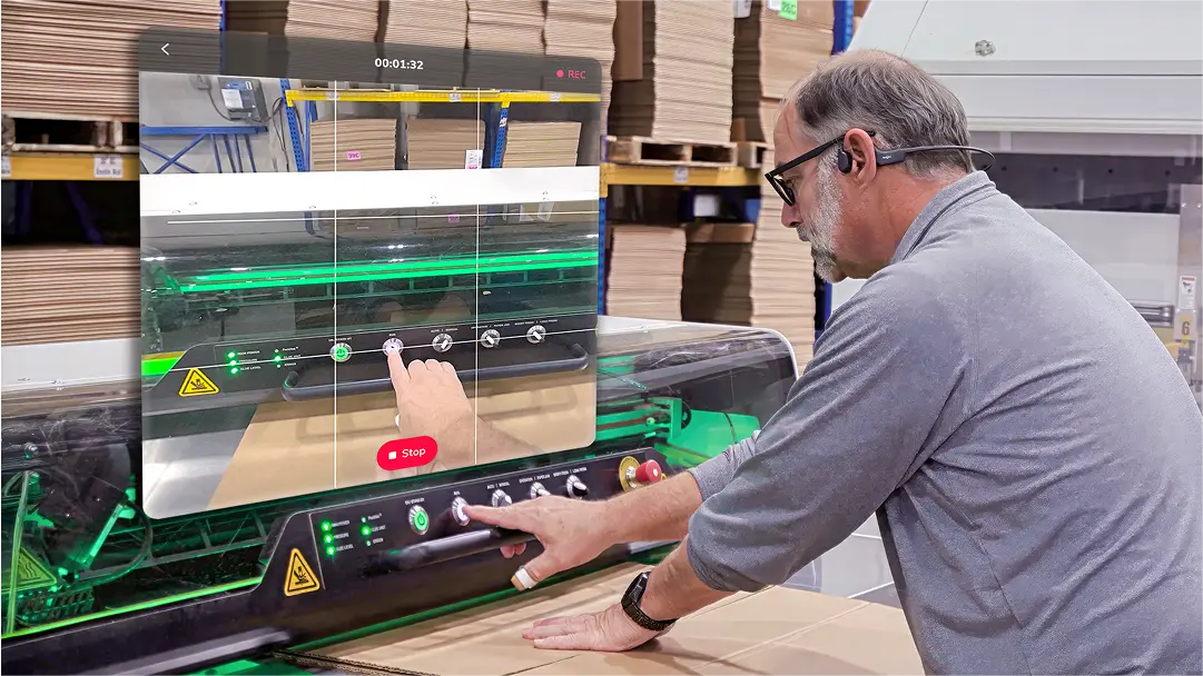 Frontline logistics worker using Strivr WorkWise to record a first-person video of how to operate a box cutting machine 