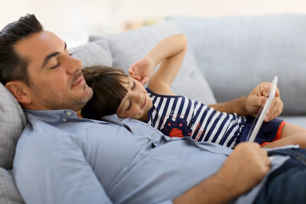 Daddy with little girl playing with tablet