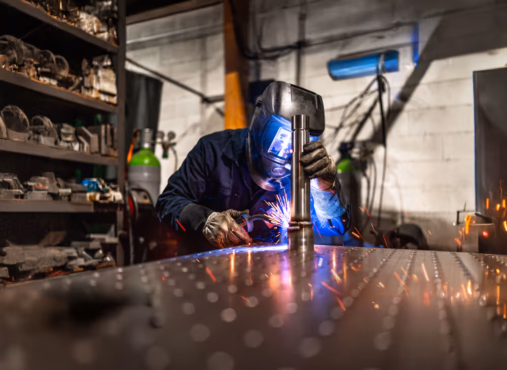 Welder welding a shaft.