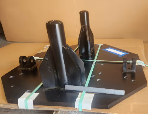 Fabricated and CNC machined steel fixture base with mounted supports, manufactured by Burns Machine Company.