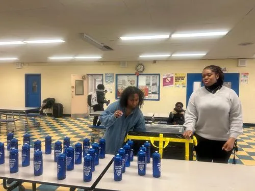 two student have groupe of bottle on 
the  table 