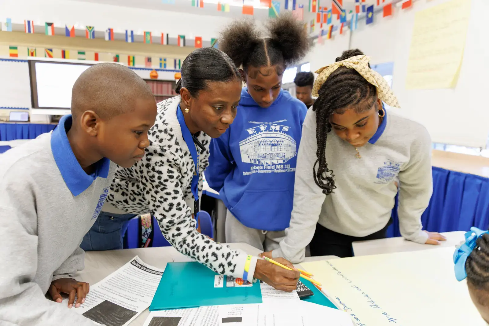 Teacher guiding middle school students through a classroom writing activity