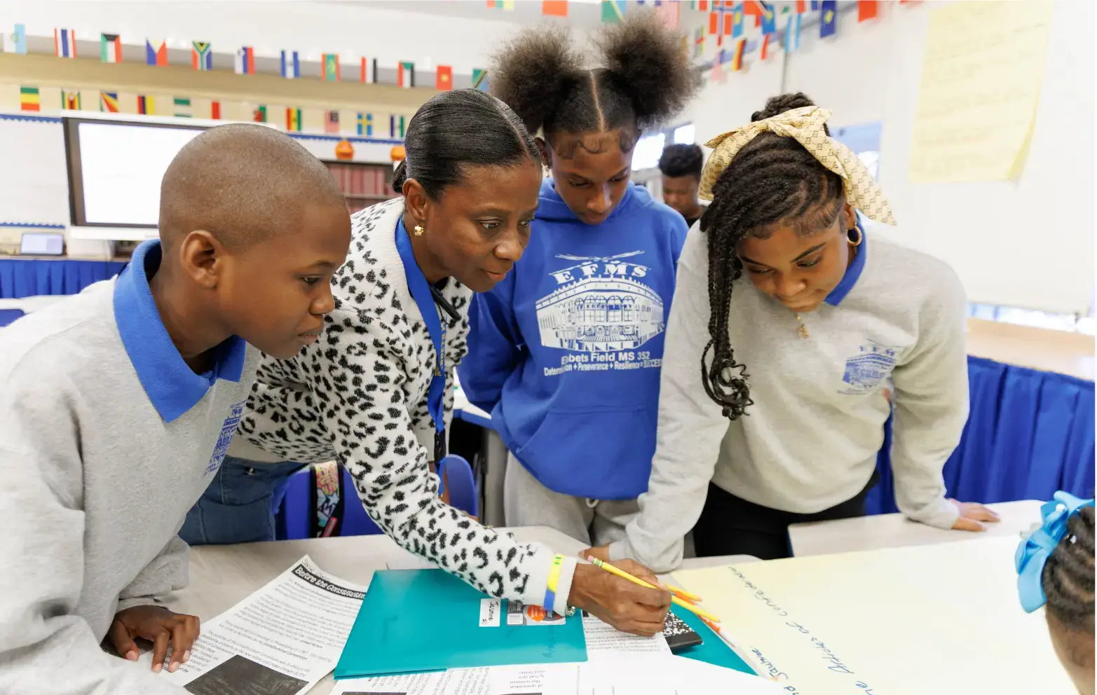 Teacher guiding middle school students through a classroom activity