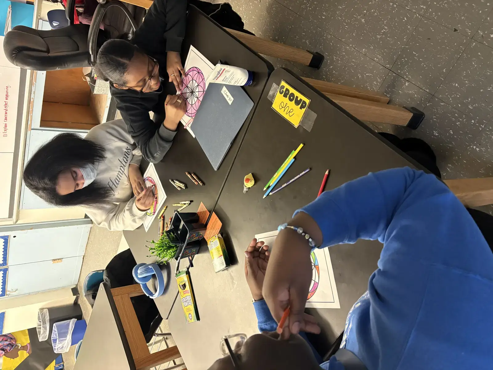 Students in Group One coloring mandala worksheets with colored pencils