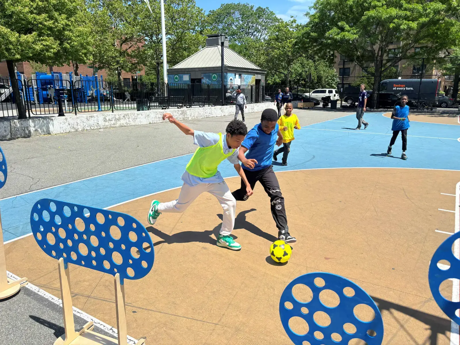 Students playing soccer on outdoor court during recess
