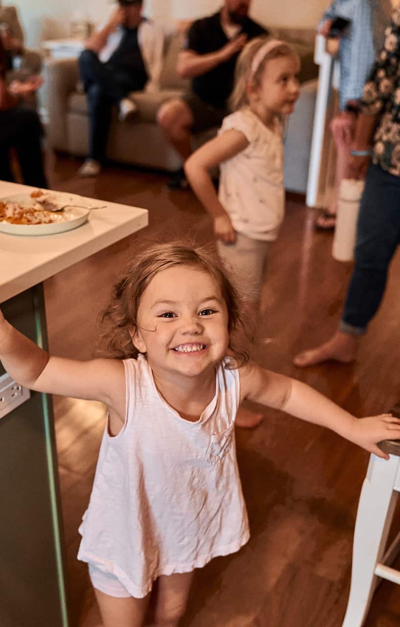 Girl smiling at the camera in her house.