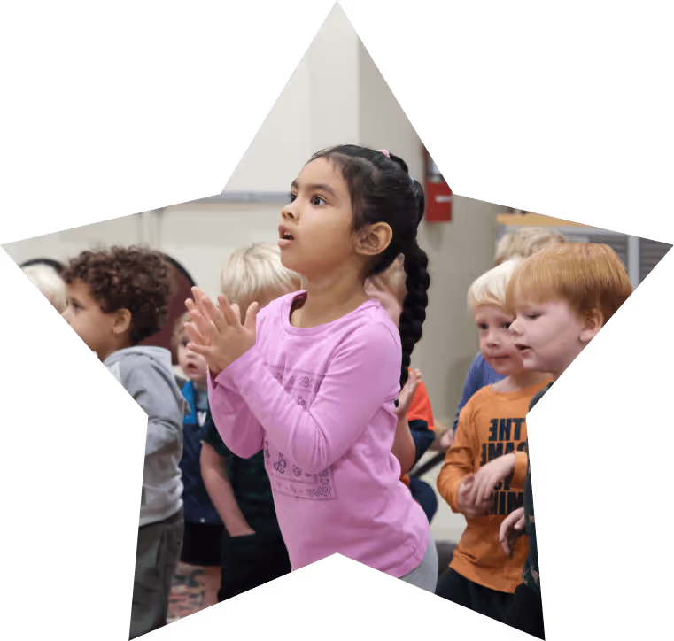 Preschool girl clapping and singing
