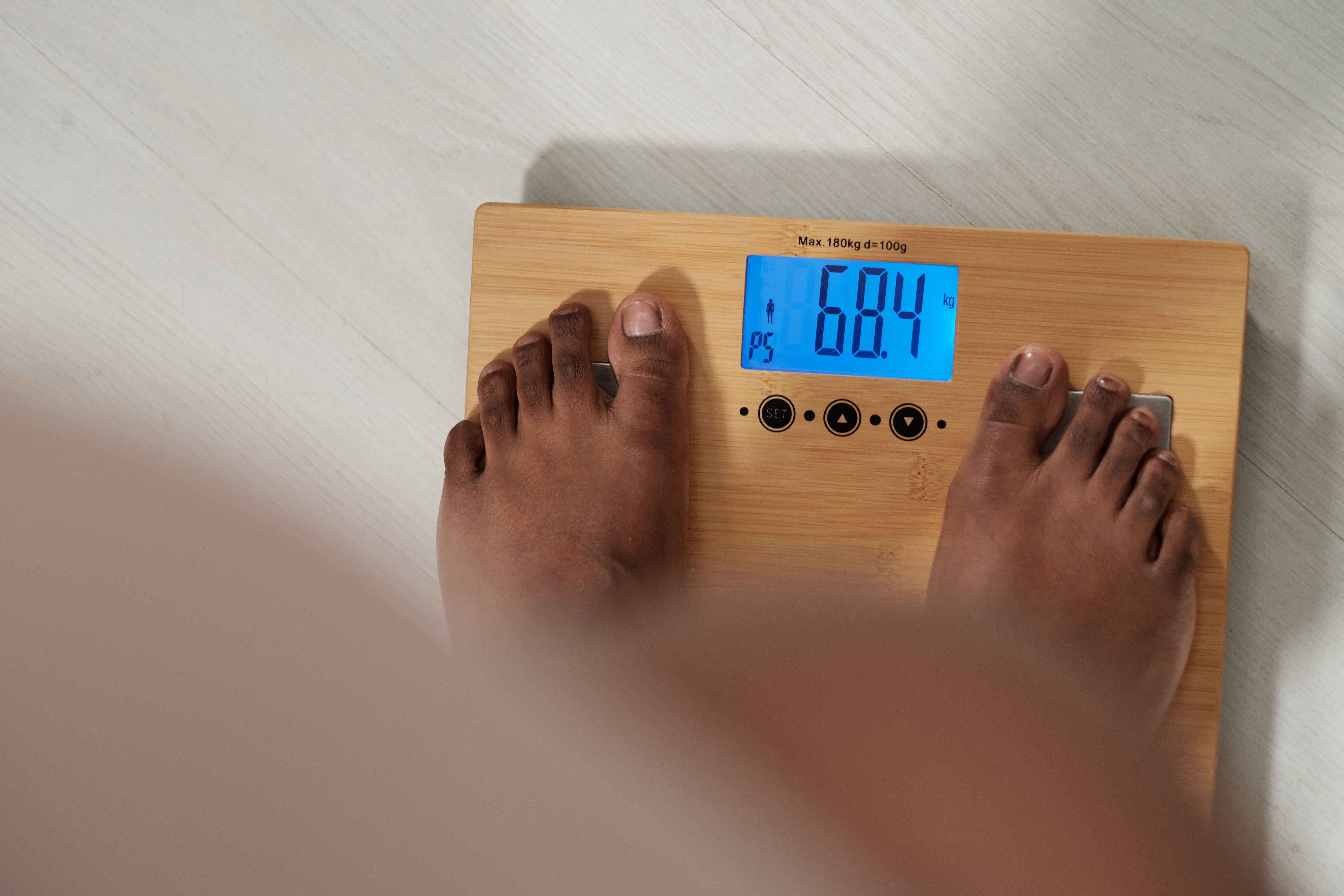 woman standing on weight scale