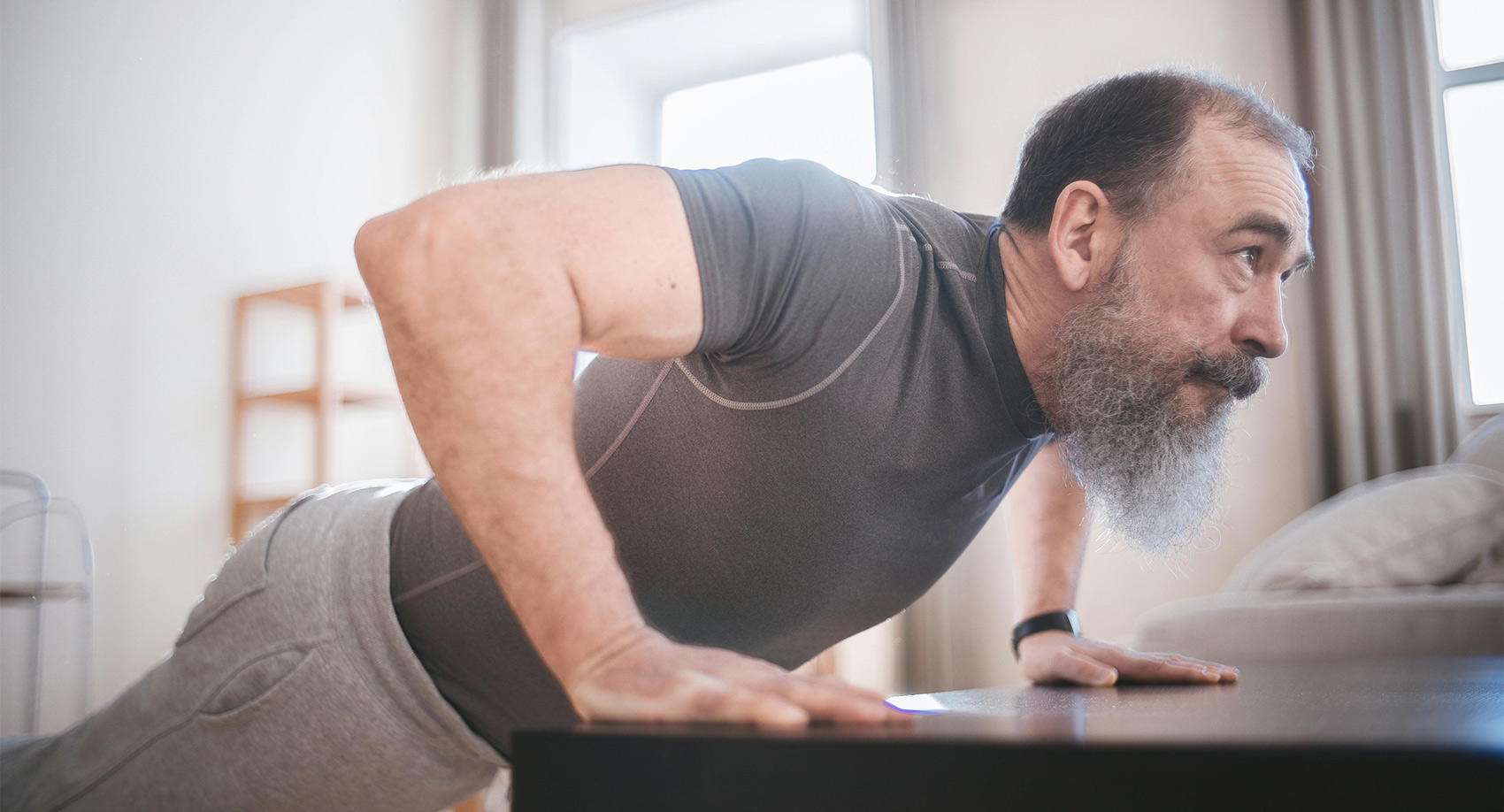 A middle-aged man does push-ups and enjoys optimal health after orthobiologics treatment in Los Angeles