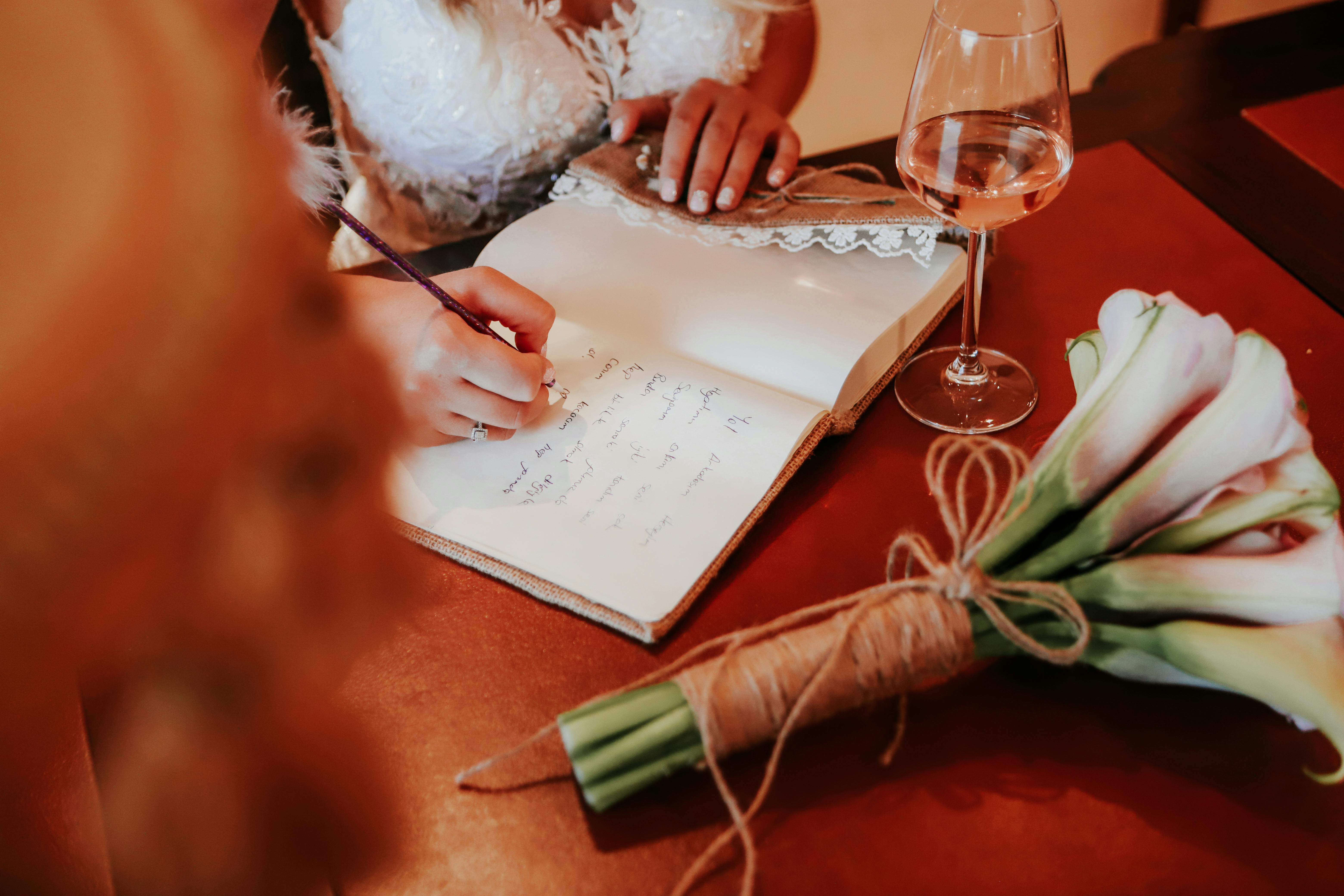 Bride signing guest book at wedding in San Diego