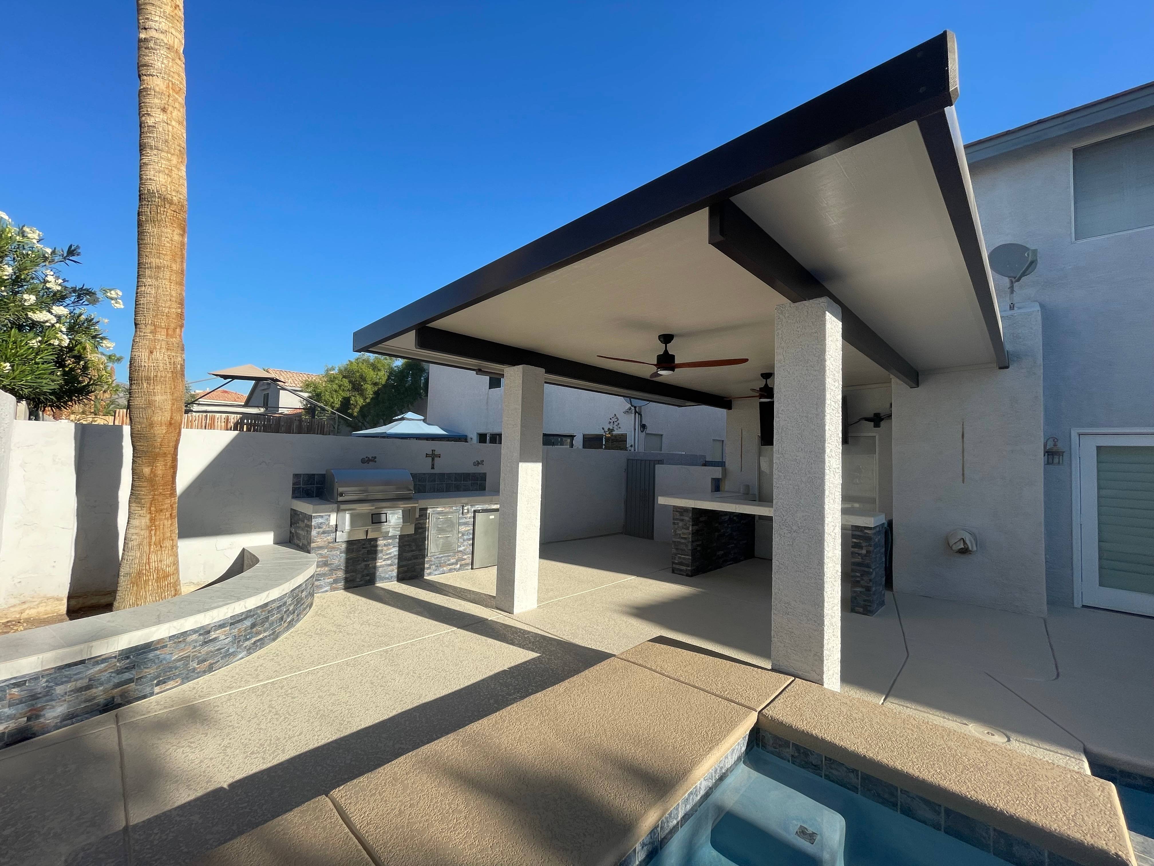 Outdoor fire pit area with circular stone seating on a gravel patio surface