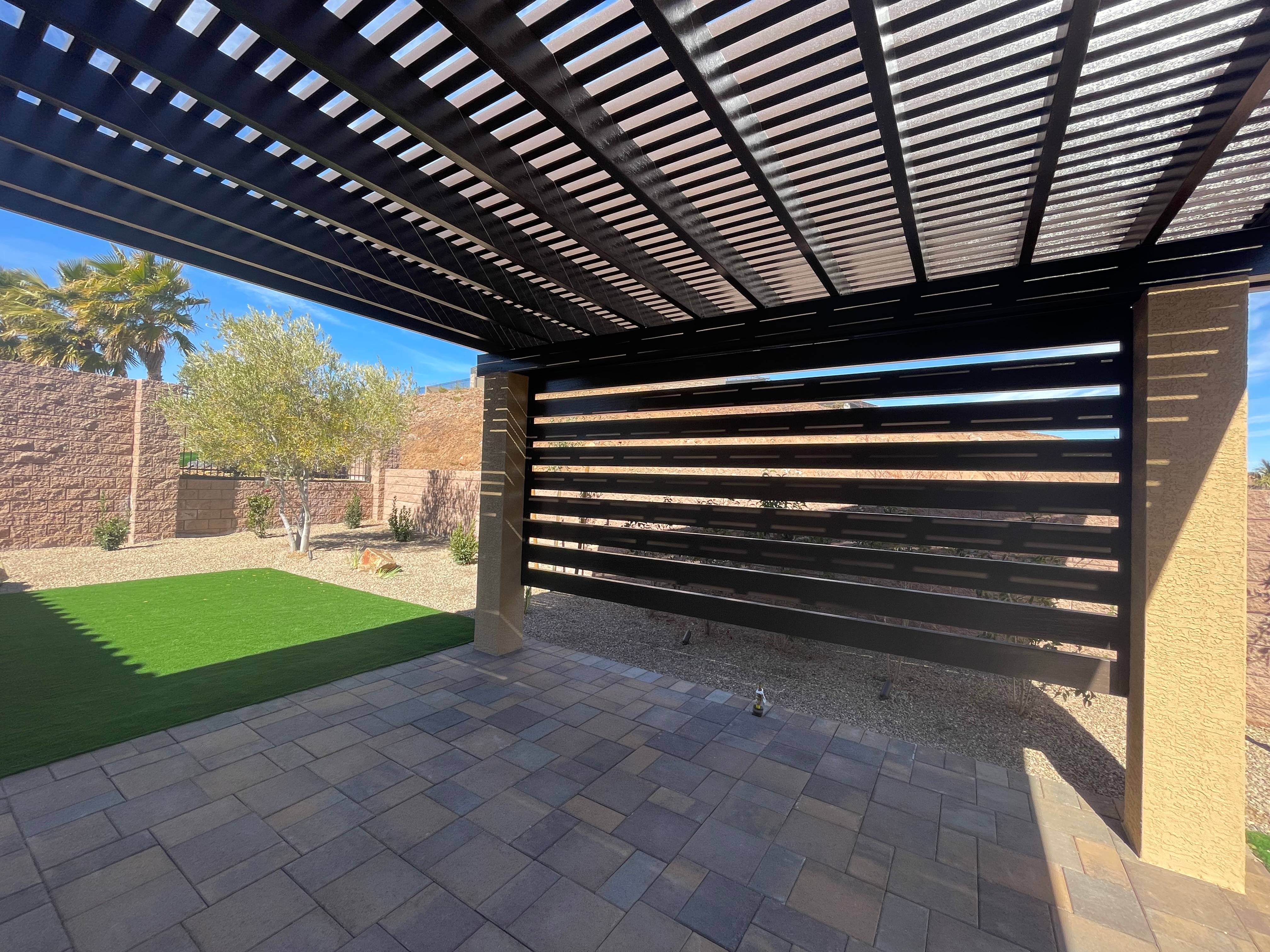 Modern poolside lounge area with sleek stone decking and minimalist landscaping
