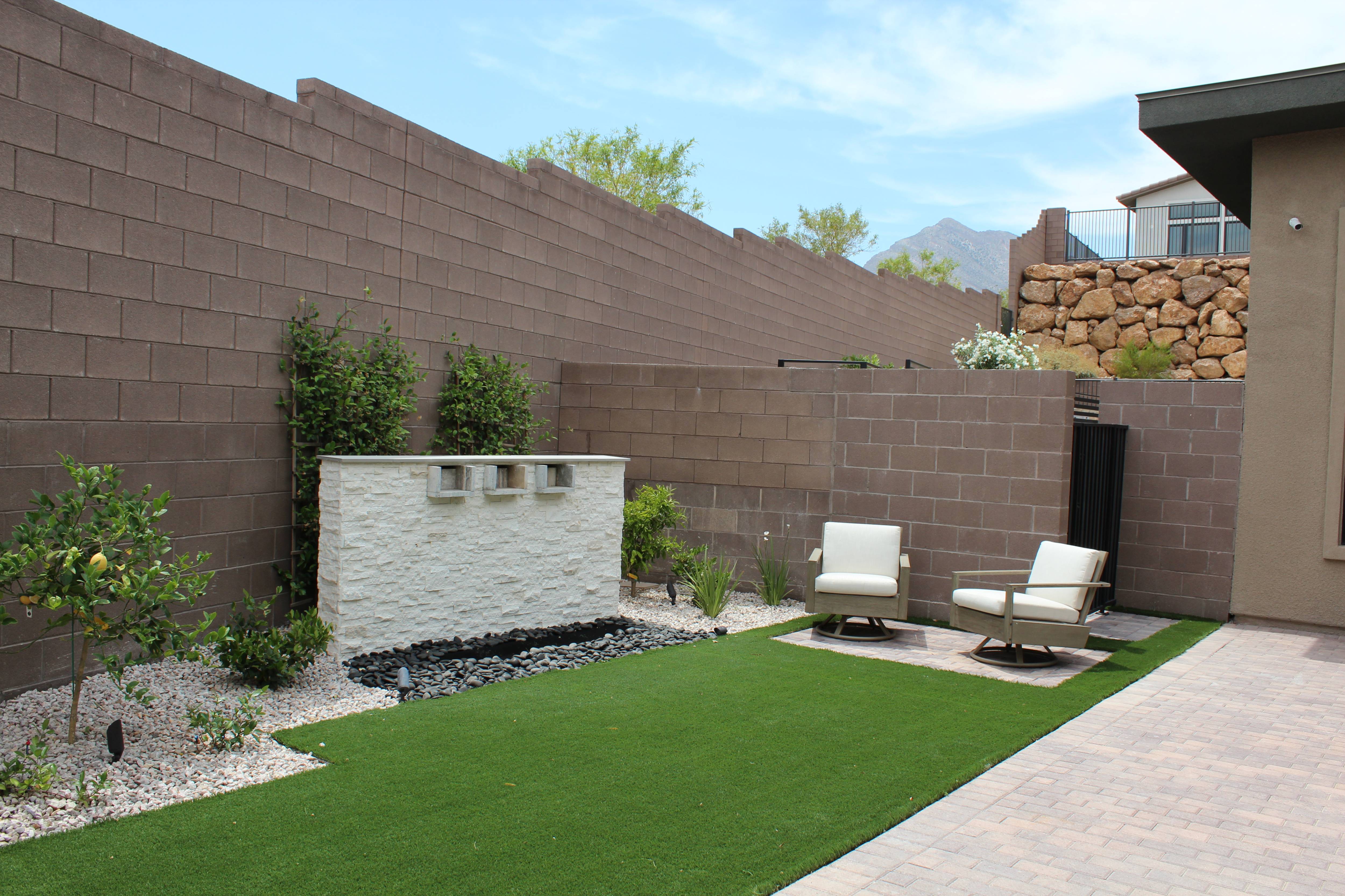 Luxurious outdoor living area with custom stone fireplace and seating area