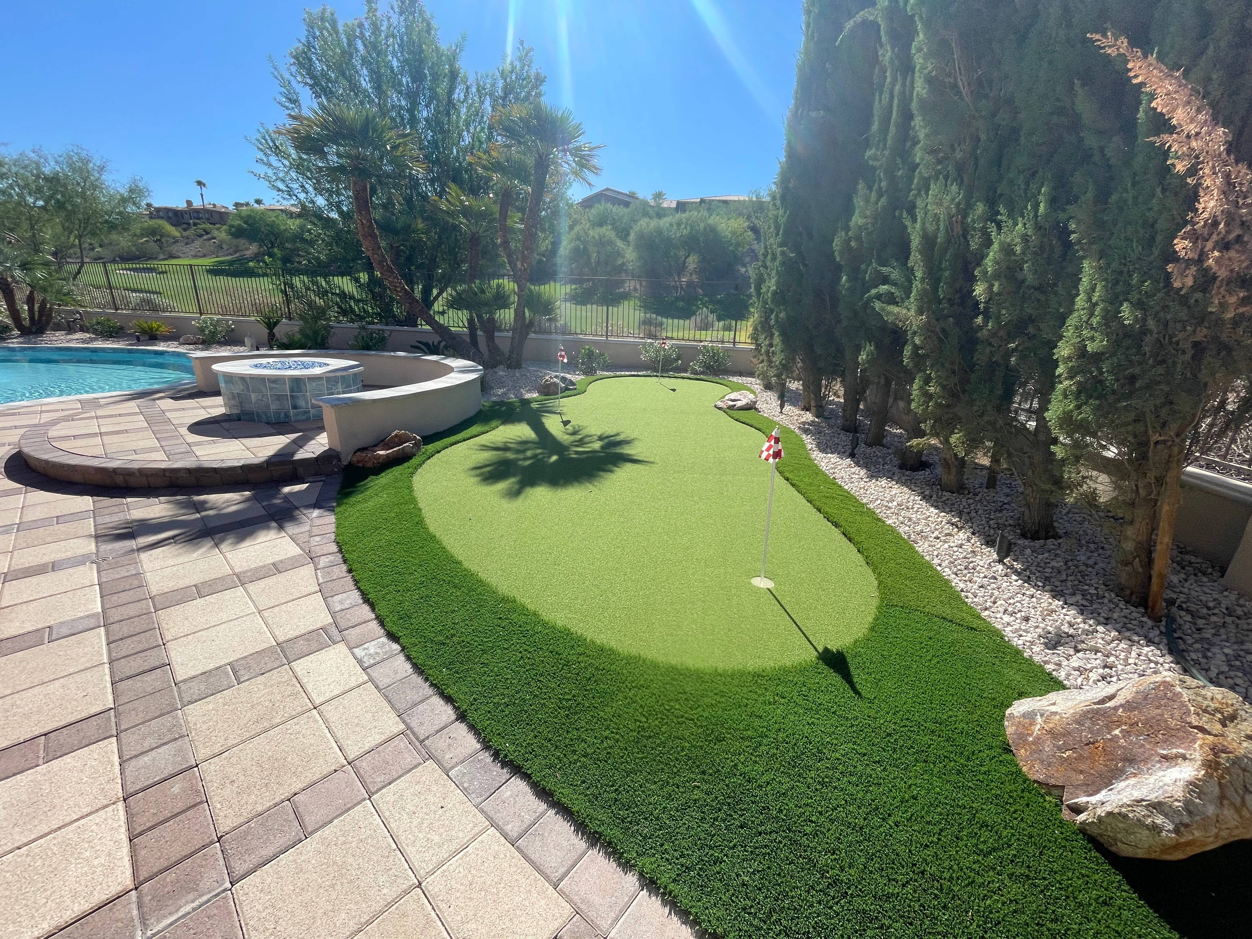 backyard golf putting area and pool