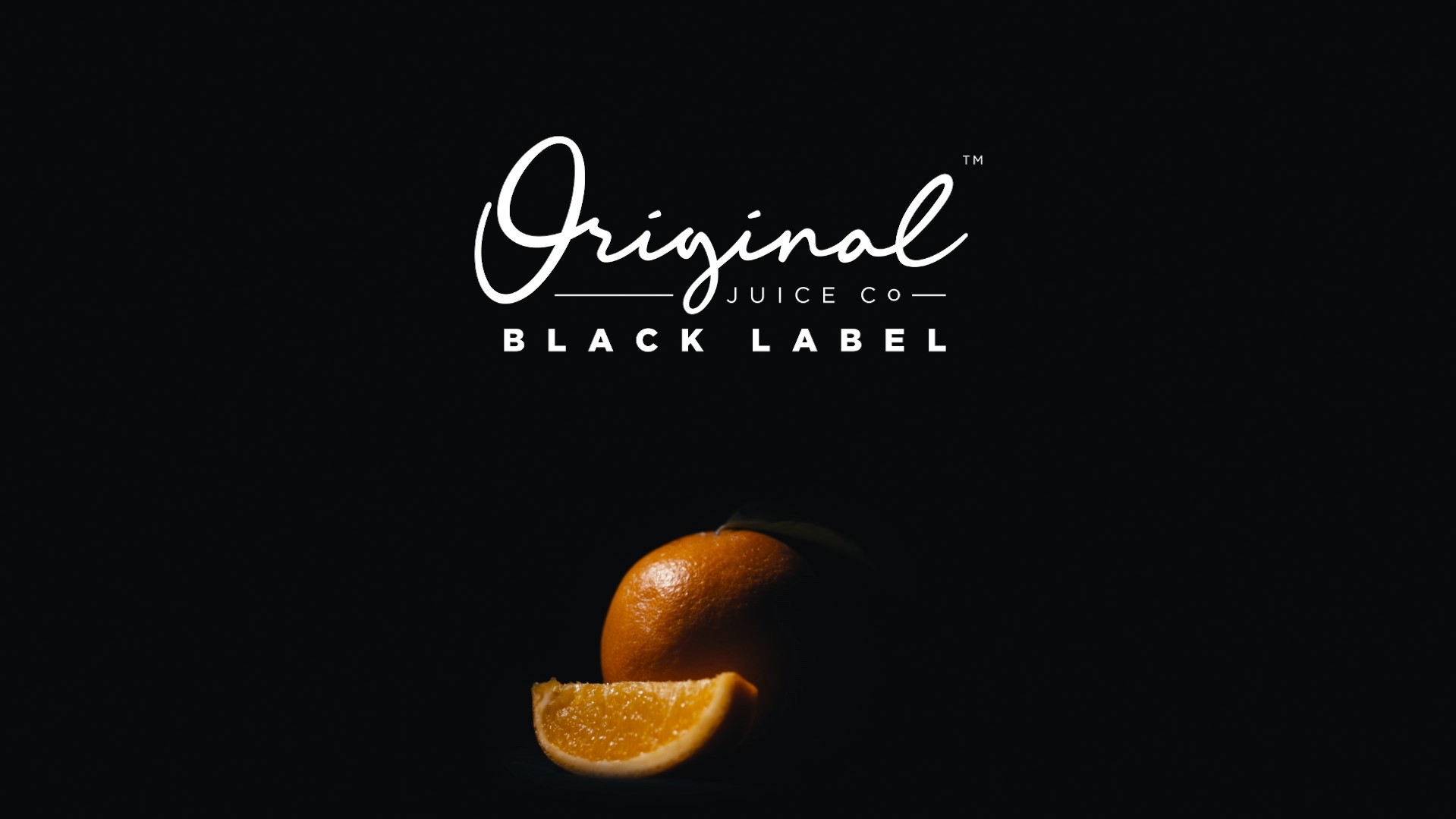An orange surrounded by darkness, with the words Original Juice Co, Black Label