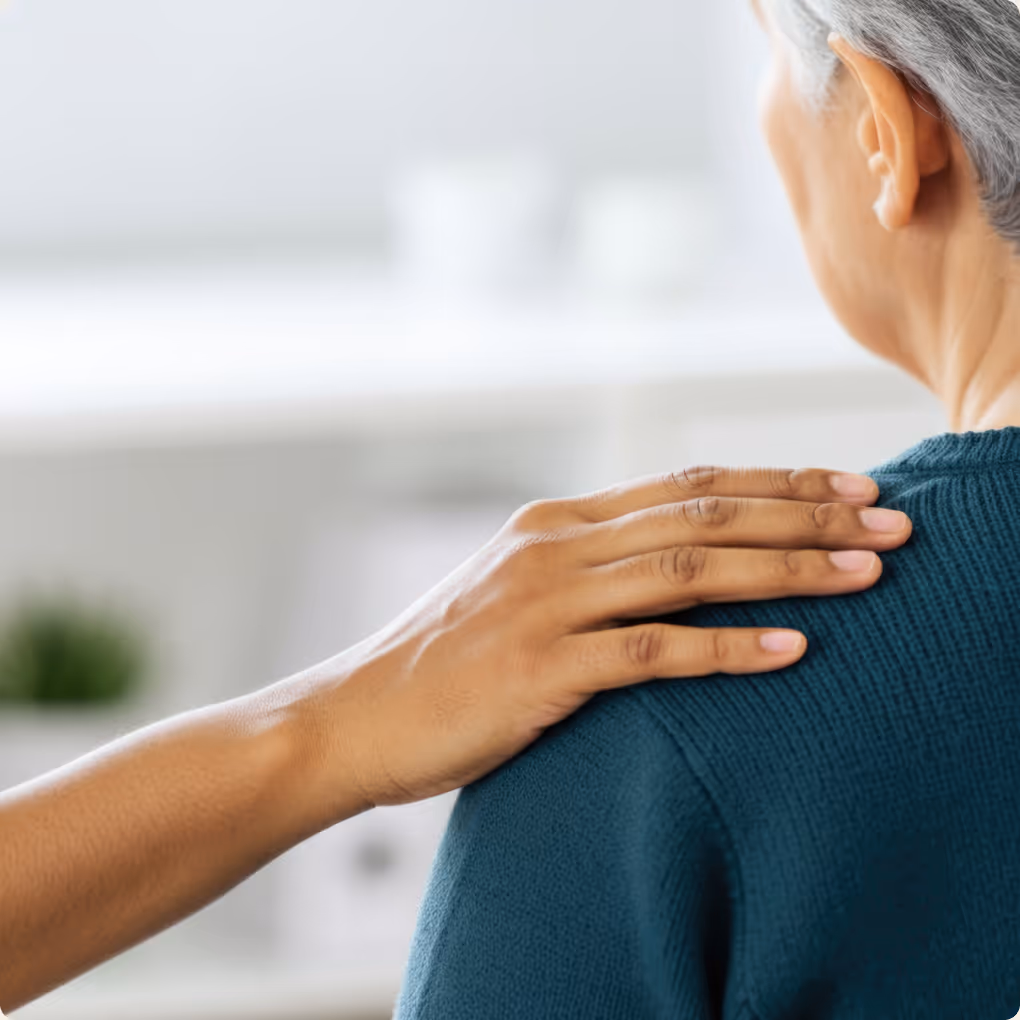A woman with her arm around the shoulder of another woman.