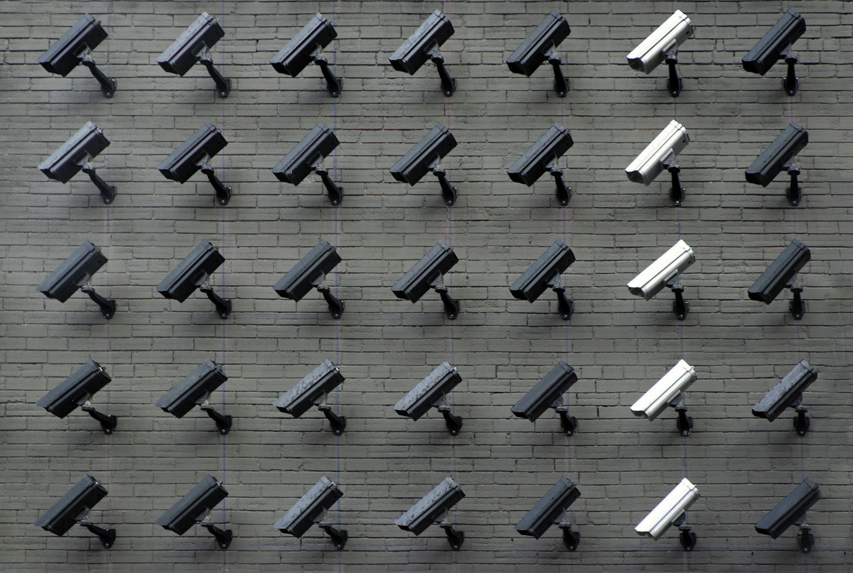Surveillance camera array symbolising digital surveillance, privacy concerns, and cybersecurity policy enforcement.