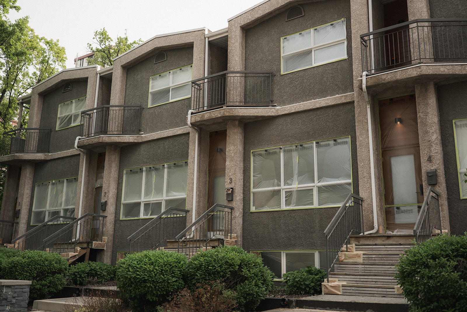 A complete exterior stucco repaint by Integrity Painting, featuring a modern grey finish that provides a fresh, updated look and superior weather protection.