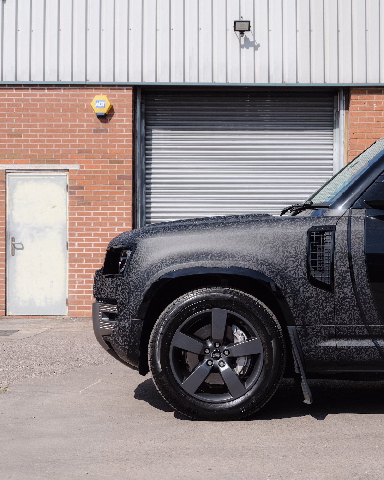 The side wing of a Land Rover Defender, wrapped by WCC.