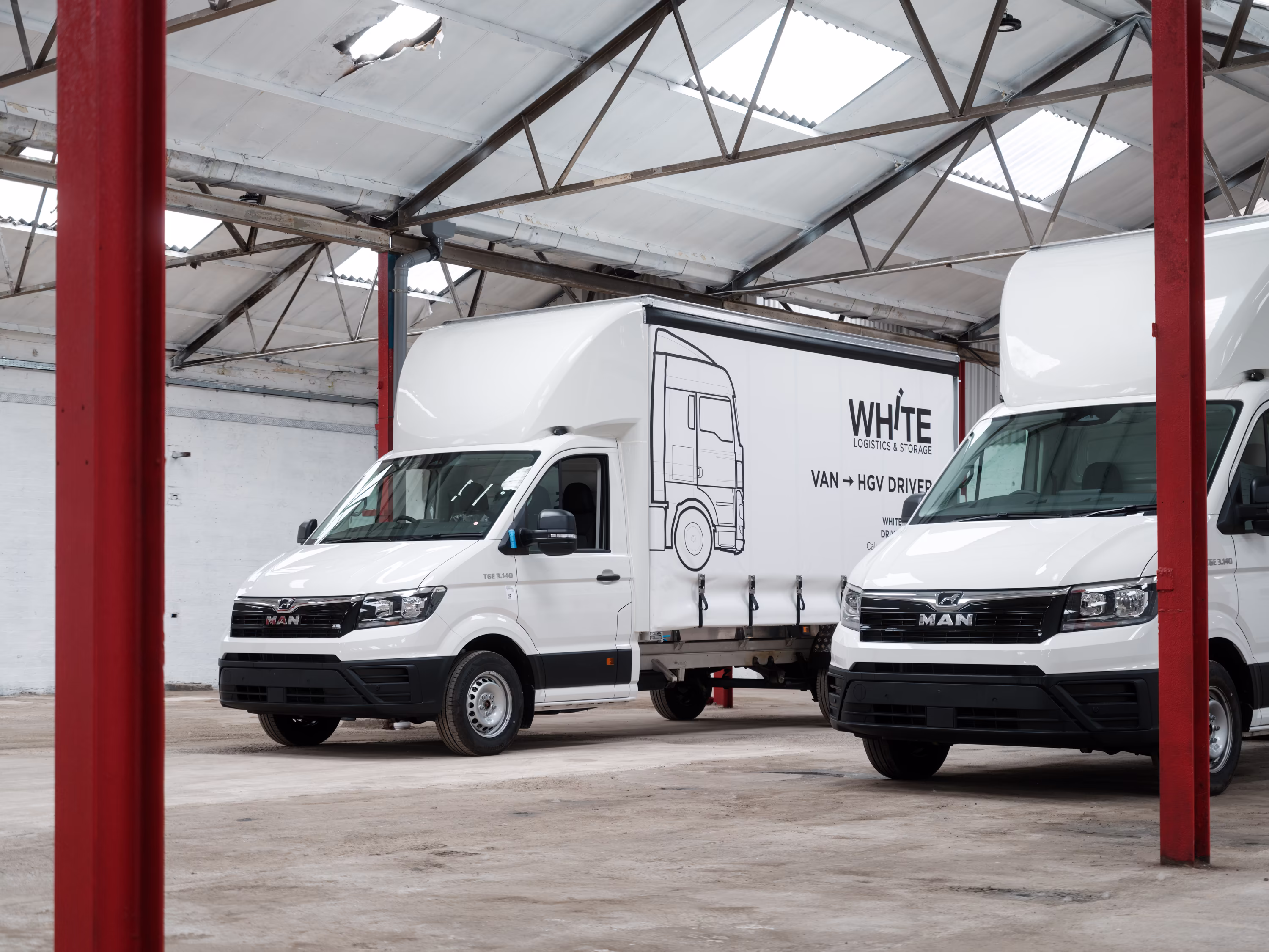 The front of two new curtain sider White Logistics vans built by WCC.