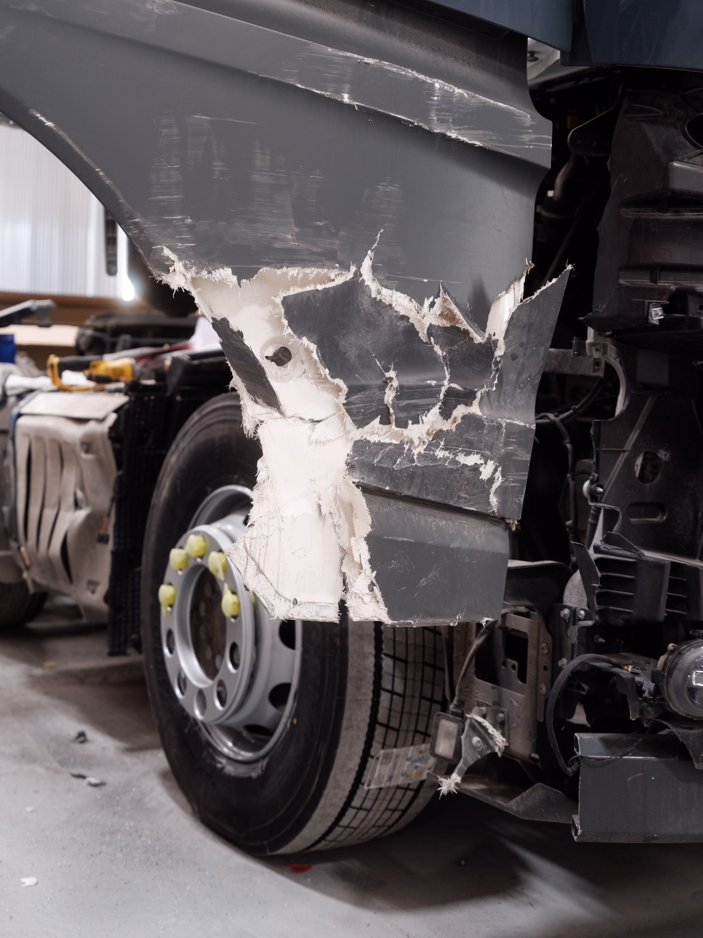 The damaged door and bumper of an Amazon HGV.