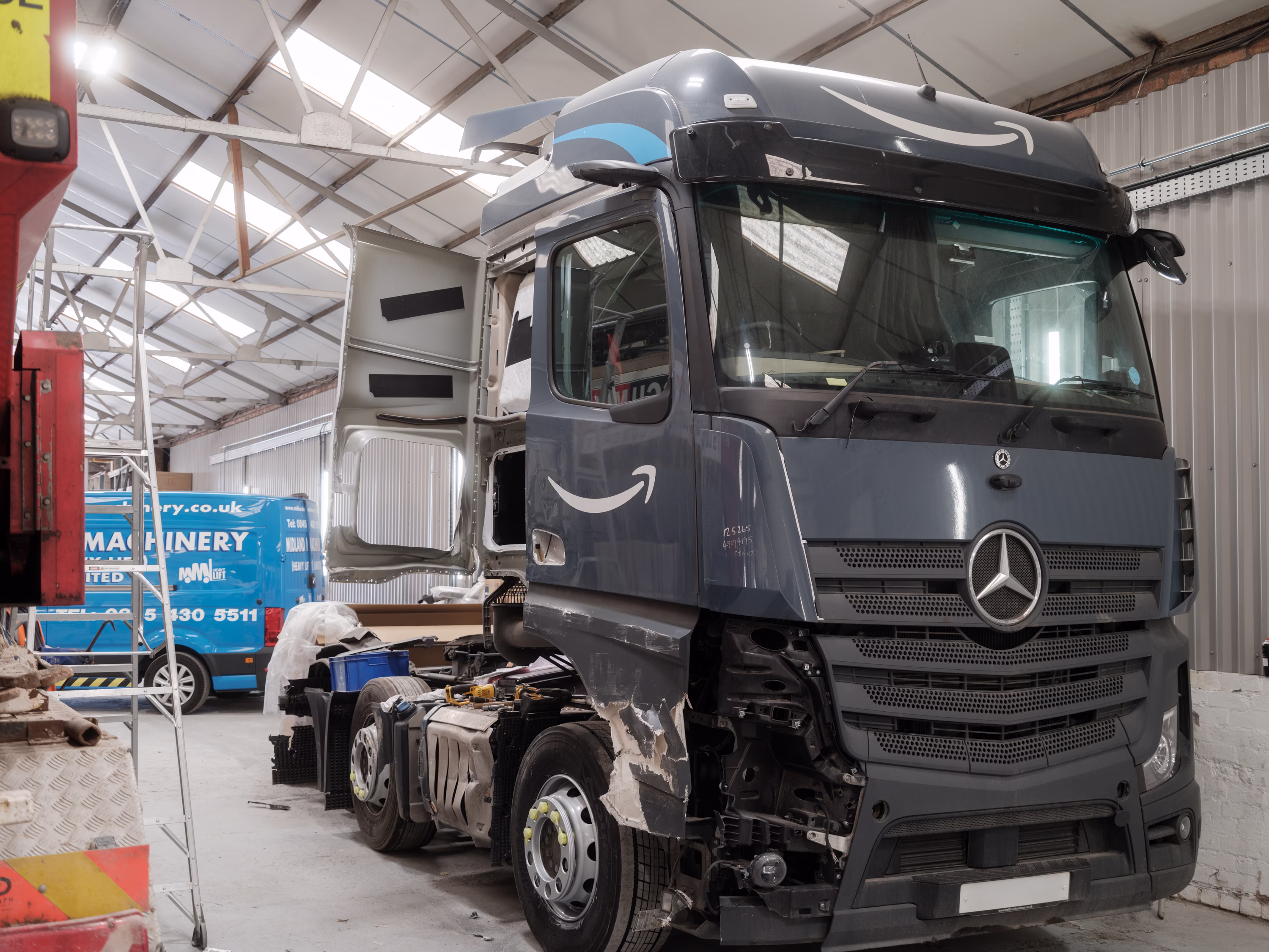 A damaged side of a Mercedes Amazon HGV.