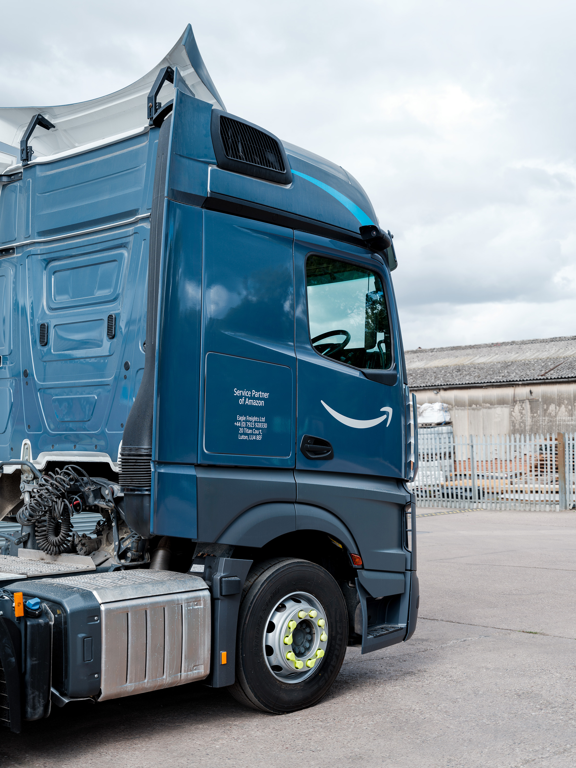 A repaired and repainted side panel of an Amazon HGV.